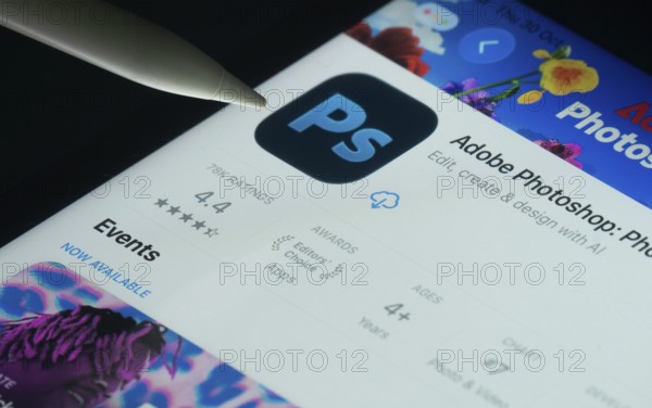 Dhaka, Bangladesh- 30 Oct 2025: Adobe Photoshop app on a iPad screen with a pen pointing at the
