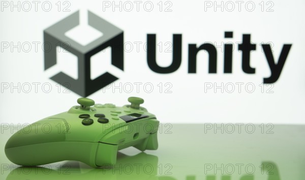 Dhaka, Bangladesh- 14 Nov 2025: A close-up of a white gamepad with the Unity seen on screen in the