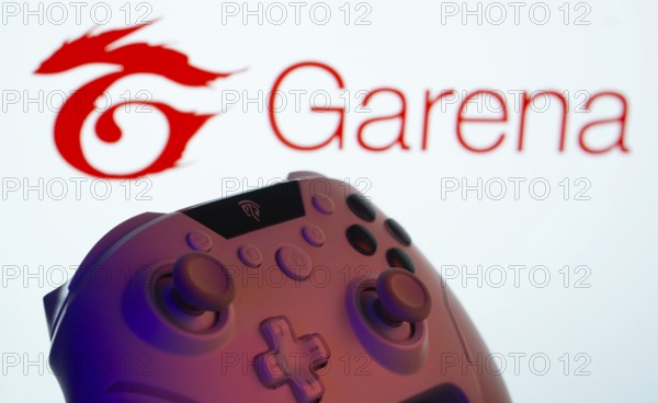 Dhaka, Bangladesh- 14 Nov 2025: A close-up of a gamepad with the Garena seen on screen in the