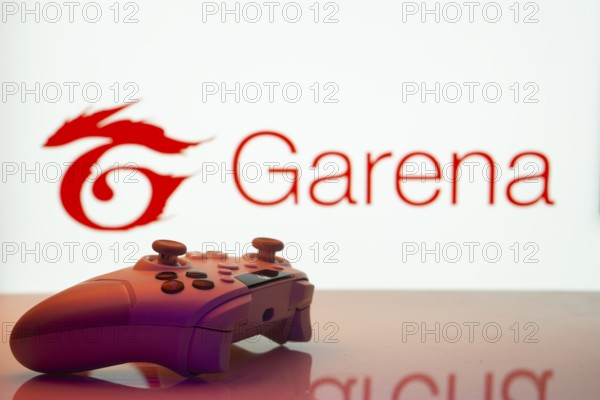 Dhaka, Bangladesh- 19 Sep 2025: A close-up of a white gamepad with the Garena seen on screen in the