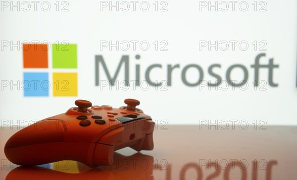 Dhaka, Bangladesh- 09 May 2025: A close-up of a white gamepad with the Microsoft seen on screen in