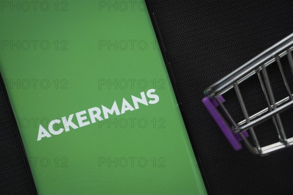 Dhaka, Bangladesh- 03 July 2025: A smartphone displaying the Ackermans logo next to a miniature
