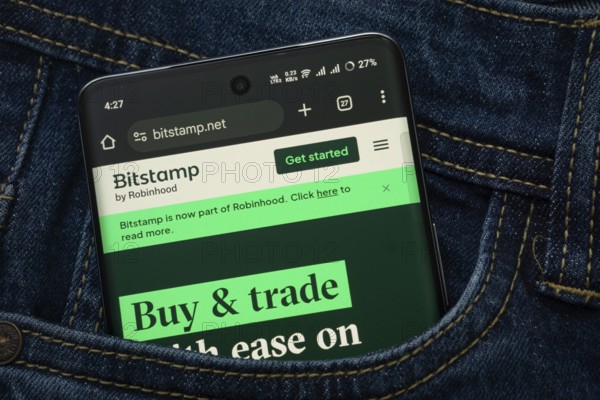 Dhaka, Bangladesh- 15 June 2025: A smartphone displaying the Bitstamp web interface peeks out of a
