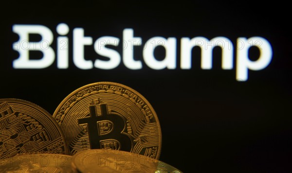 Dhaka, Bangladesh- 03 Sep 2025: Close-up of Bitcoin coins with the Bitstamp logo visible on a