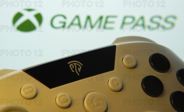 Dhaka, Bangladesh- 01 Nov 2025: A close-up of a gamepad with the Xbox Game Pass seen on screen in