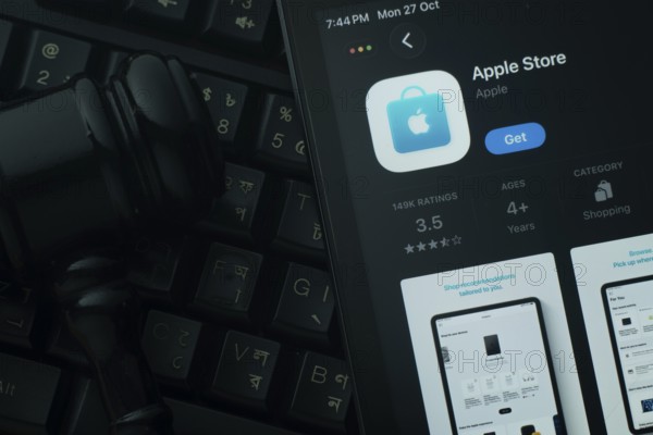 Dhaka, Bangladesh- 28 Oct 2025: An iPad displaying the Apple Store app against a judge's gavel and