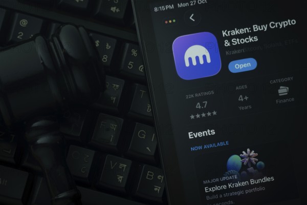 Dhaka, Bangladesh- 28 Oct 2025: An iPad displaying the Kraken app against a judge's gavel and dark