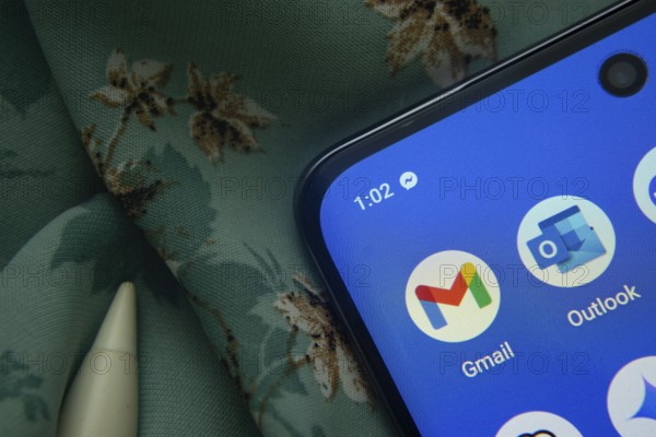 Dhaka, Bangladesh- 07 May 2025: Gmail and Outlook app icon is seen on smartphone