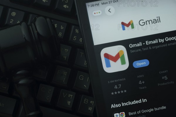 Dhaka, Bangladesh- 28 Oct 2025: An iPad displaying the Gmail app against a judge's gavel and dark
