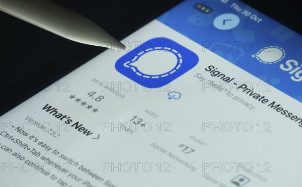 Dhaka, Bangladesh- 30 Oct 2025: Signal app on a iPad screen with a pen pointing at the install
