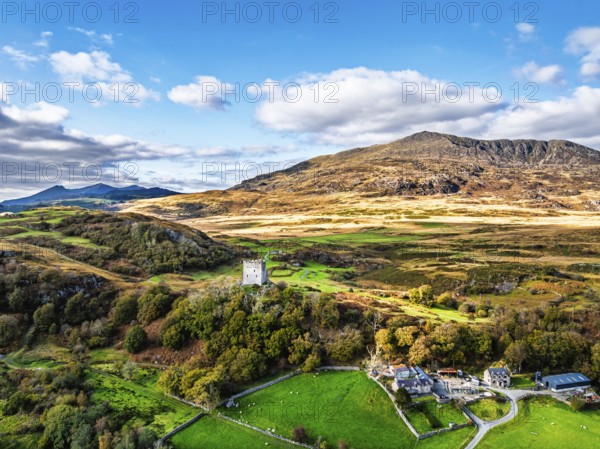 Autumn colours over Castell Dolwyddelan and Eryri Mountains from a drone, Snowdonia, Conwy County