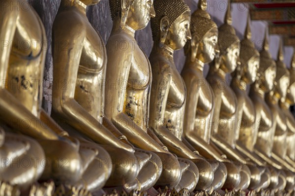 Gilded Buddha statues (Bhumispara mudra: Buddha Gautama at the moment of enlightenment), Wat Suthat