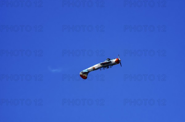 A Jakovlev Jak-52 with registration LY-HLZ during a flight demonstration as part of an air show on