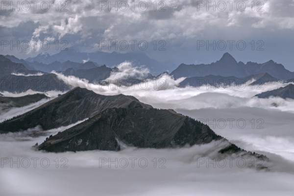 View from the Nebelhorn summit to mountains of the Allgäu Alps, mountains rising from fog in the