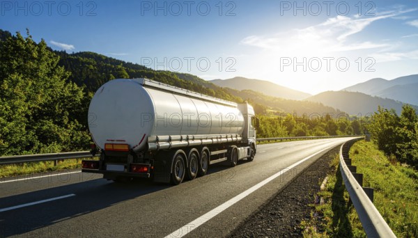 Petrol cargo truck lorry tanker driving on highway hauling oil products at sunrise, wide hilly