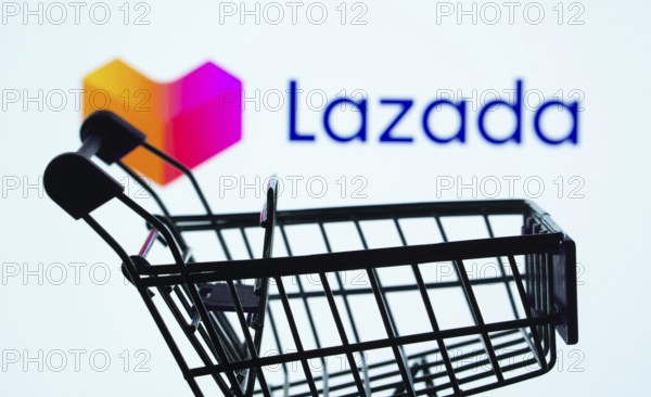 Dhaka, Bangladesh- 03 July 2025: Silhouette of a shopping cart in front of the Lazada logo,