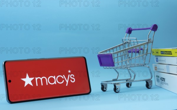 Dhaka, Bangladesh- 03 July 2025: Smartphone with Macy's logo next to a small shopping cart and