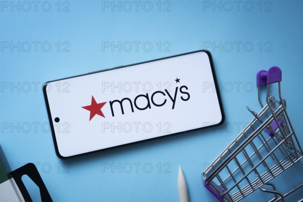 Dhaka, Bangladesh- 03 July 2025: Smartphone displaying Macy's logo with shopping cart on a blue