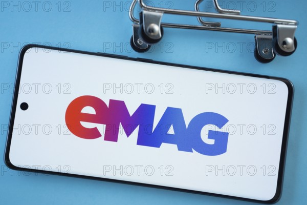 Dhaka, Bangladesh- 03 Oct 2025: Smartphone screen showing the Emag logo with shopping cart wheels