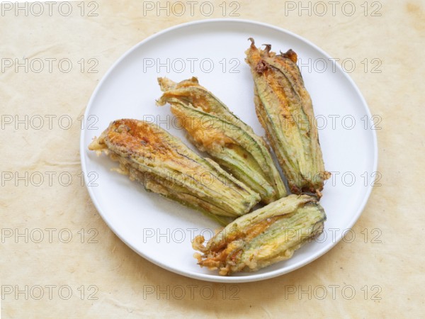 Zucchini flowers fried and stuffed on a plate offering a gourmet snack
