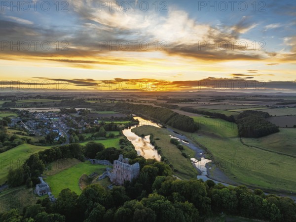 Sunset over Norham Castle and River Tweed from a drone, Norham, Northumberland, England, United