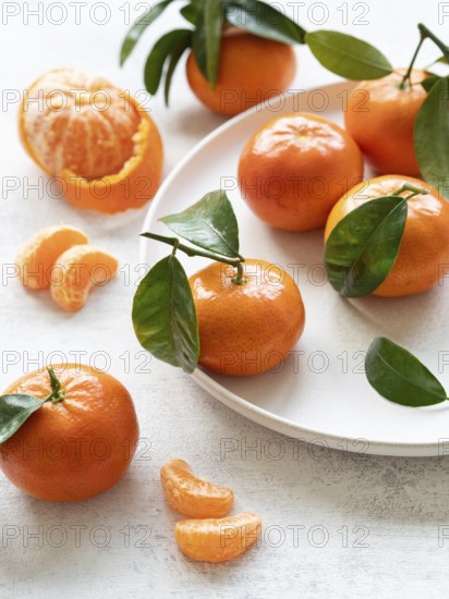 Vibrant tangerines with green leaves, showcasing freshness and citrusy appeal, perfect for healthy