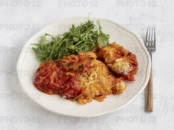 Enjoying a healthy and delicious meal of courgette spaghetti with tomato sauce, parmesan cheese,