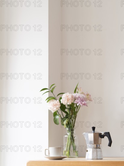 Enjoying a quiet moment with coffee and flowers, creating a cozy and relaxing atmosphere in a