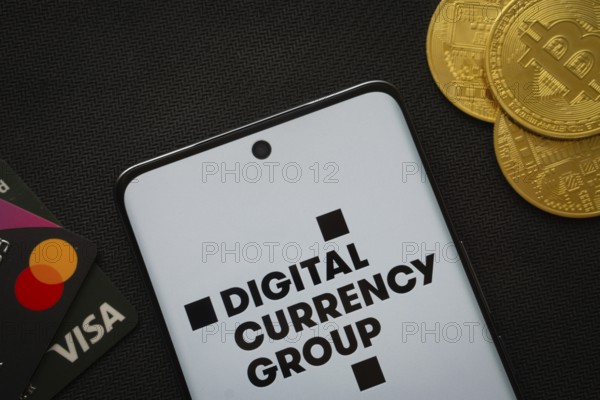 Dhaka, Bangladesh- 03 Oct 2025: Smartphone displaying Digital currency group logo surrounded by