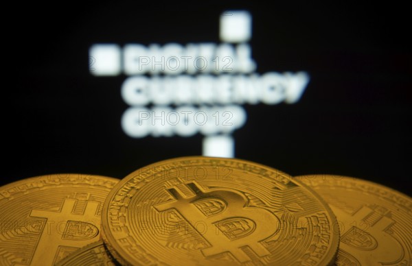 Dhaka, Bangladesh- 03 Oct 2025: Close-up of Bitcoin coins with the Digital currency group logo