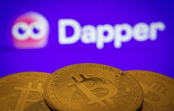Dhaka, Bangladesh- 03 Oct 2025: Close-up of Bitcoin coins with the Dapper logo visible on a screen