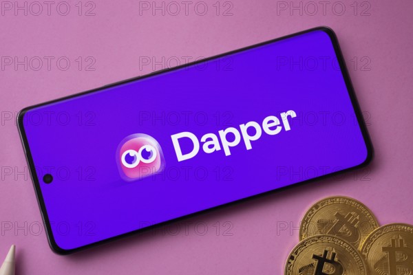 Dhaka, Bangladesh- 03 Oct 2025: Dapper logo on smartphone screen near Bitcoin coin and QR code on