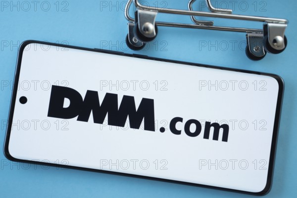 Dhaka, Bangladesh- 03 Oct 2025: Smartphone screen showing the Dmm.com logo with shopping cart