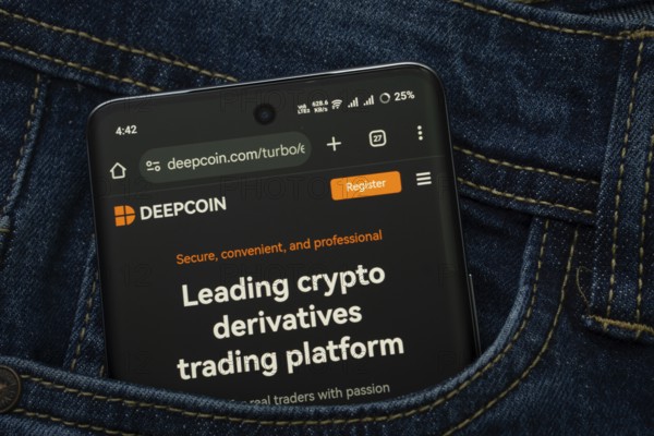 Dhaka, Bangladesh- 03 Oct 2025: A smartphone displaying the Deepcoin web interface peeks out of a