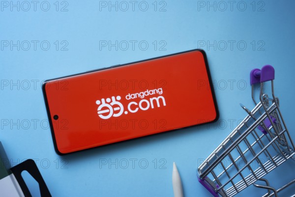 Dhaka, Bangladesh- 03 July 2025: Smartphone displaying Dangdang.com logo with shopping cart on a
