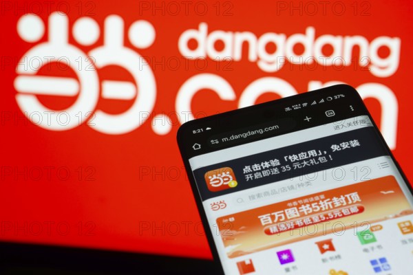 Dhaka, Bangladesh- 03 Oct 2025: Smartphone displaying Dangdang.com web interface against Dangdang