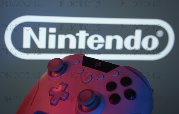 Dhaka, Bangladesh- 15 July 2025: A close-up of a gamepad with the nintendo seen on screen in the