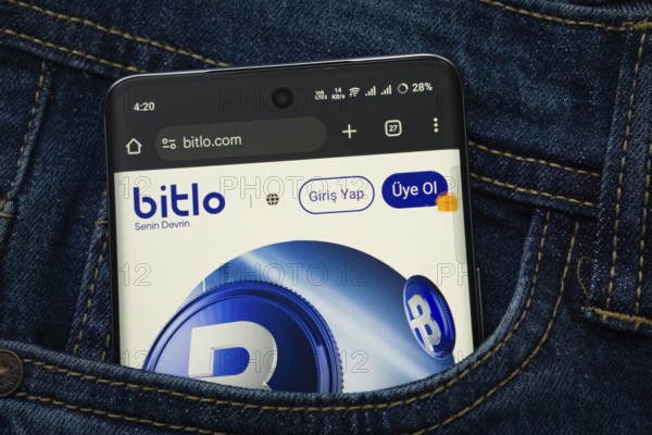 Dhaka, Bangladesh- 15 June 2025: A smartphone displaying the Bitlo.com web interface peeks out of a