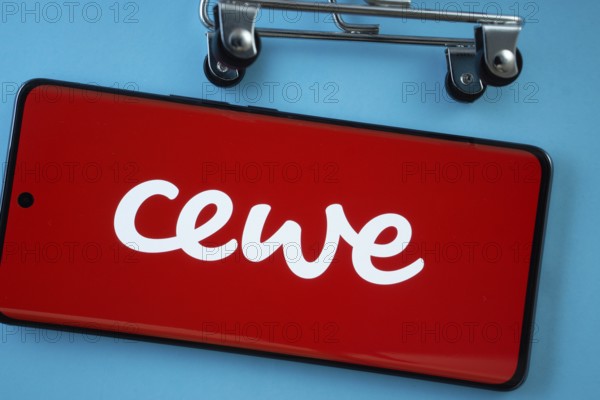 Dhaka, Bangladesh- 03 July 2025: Smartphone screen showing the Cewe logo with shopping cart wheels