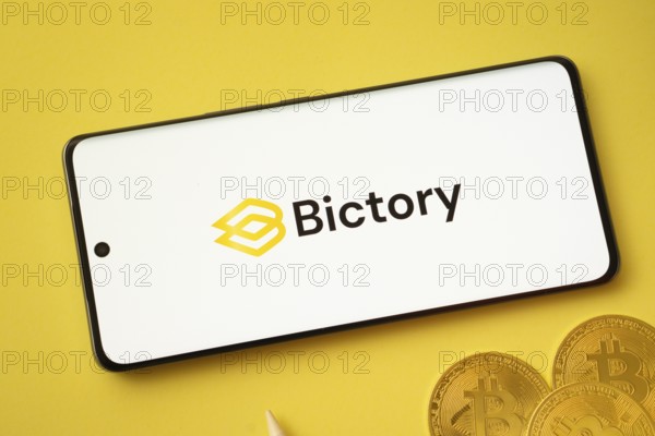 Dhaka, Bangladesh- 09 Sep 2025: Bictory logo on smartphone screen near Bitcoin coin and QR code on