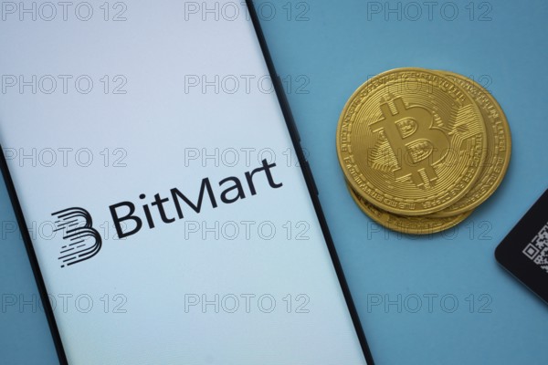 Dhaka, Bangladesh- 03 Sep 2025: Bitmart logo on smartphone screen near Bitcoin coin and QR code on