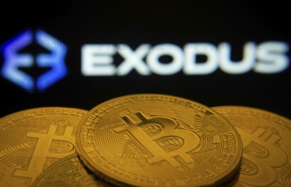Dhaka, Bangladesh- 06 Sep 2025: Close-up of Bitcoin coins with the Exodus logo visible on a screen