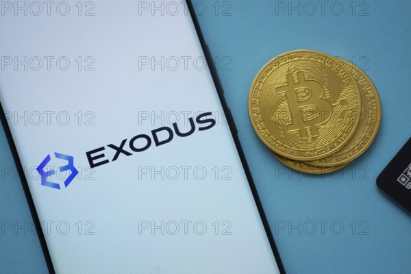 Dhaka, Bangladesh- 06 Sep 2025: Exodus logo on smartphone screen near Bitcoin coin and QR code on