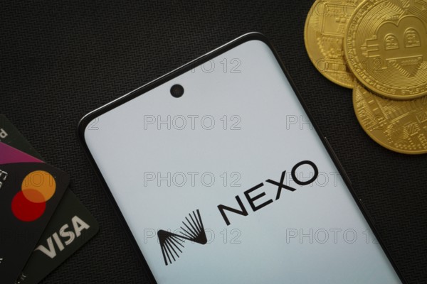 Dhaka, Bangladesh- 06 Sep 2025: Smartphone displaying nexo logo surrounded by Bitcoin coins and