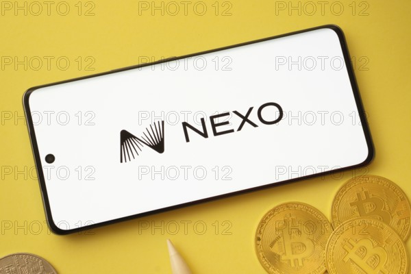 Dhaka, Bangladesh- 06 Sep 2025: Nexo logo on smartphone screen near Bitcoin coin and QR code on
