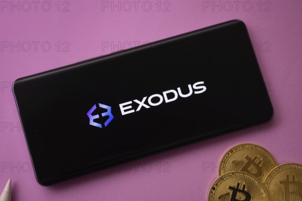 Dhaka, Bangladesh- 06 Sep 2025: Exodus logo on smartphone screen near Bitcoin coin and QR code on