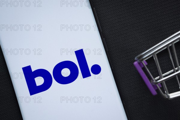 Dhaka, Bangladesh- 03 July 2025: A smartphone displaying the bol logo next to a miniature shopping