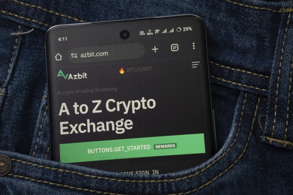 Dhaka, Bangladesh- 15 June 2025: A smartphone displaying the Azbit.com web interface peeks out of a