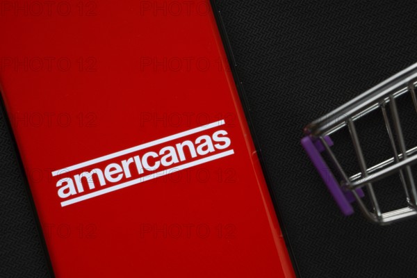 Dhaka, Bangladesh- 03 July 2025: A smartphone displaying the Americanas logo next to a miniature