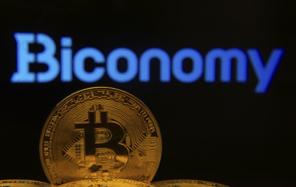 Dhaka, Bangladesh- 02 June 2025: Close-up of Bitcoin coins with the Biconomy logo visible on a